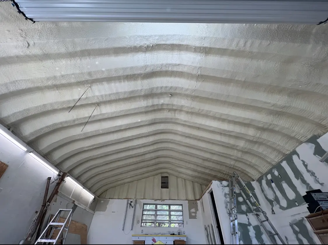 Spray polyurethane foam applied to the underside of a metal roof deck in Laketon